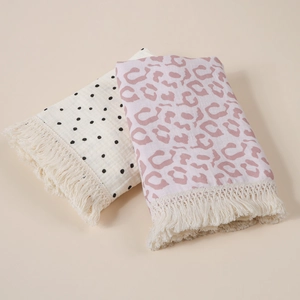 Detailed view of soft cotton baby blankets with tassel fringe and stylish prints.