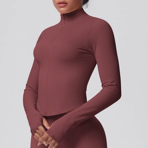 Detail of burgundy fitness jacket featuring a full zipper, high neck, and thumbhole cuffs