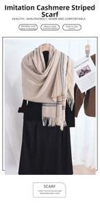 Detail of warm striped cashmere-like scarf with fringe on a minimalist display
