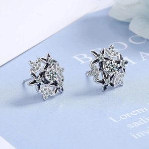 Elegant silver snowflake stud earrings featuring white cubic zirconia and floral design