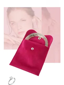 Detailed view of rose red velvet jewelry pouch with emerald green jade bangle