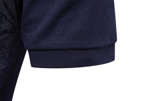 Close-up of navy blue pique cotton polo shirt sleeve with ribbed cuff texture