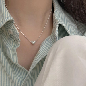 Minimalist 925 sterling silver heart pendant necklace on snake chain worn on model
