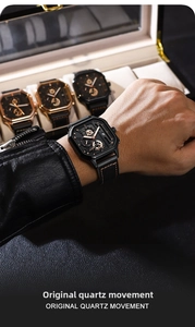 Detail of square black chronograph watch with rose gold indices and orange stitched strap