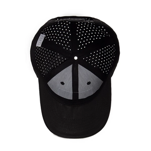 Internal view of black mesh baseball cap showing 100% polyester fabric and laser cut holes
