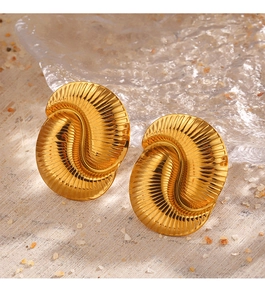 Detailed view of 18K gold plated textured shell earrings on sand background