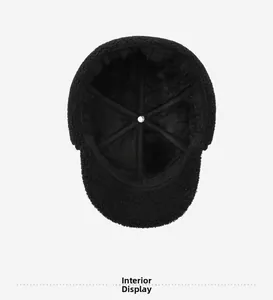 Detail view of the warm faux fur lining and inner stitching of the black winter trapper hat