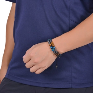 Close-up of dual-layer tiger eye and black hematite beaded bracelet on a male wrist