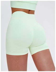 Macro shot of mint green high-waisted seamless yoga shorts showing ribbed waistband