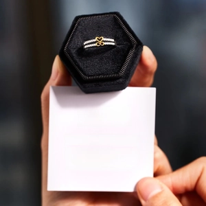 Detailed view of silver ring with infinity heart design in premium black velvet jewelry box