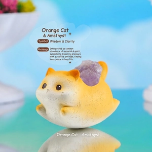 Macro detail of cute orange cat resin figurine with raw purple amethyst crystal inlay