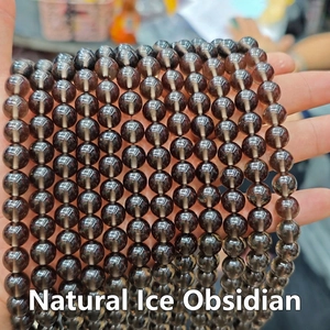 Close-up of translucent natural ice obsidian beads with smooth polished finish