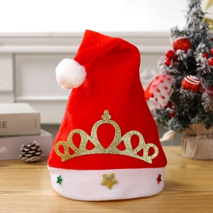 Red Christmas hat with golden crown and colorful star sequins on festive wood background