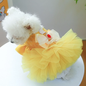 Detail of yellow pet wedding dress featuring mesh layers and a pearl ruby bow decoration