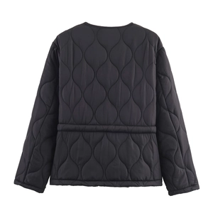 Back view of a black quilted cotton jacket with a clean minimalist belted waist design
