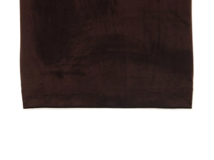 Close-up of dark brown velvet fabric showing soft texture and subtle sheen on the hemline