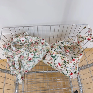 Floral cotton tote bags with red rose and colorful patterns inside a shopping cart