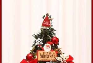 Detail of Christmas tree toppers featuring Santa clips, hats and Merry Christmas ornaments