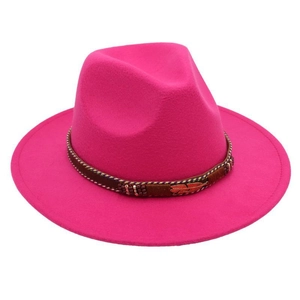 Detailed view of magenta felt fedora with braided band and golden feather pendant charm
