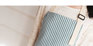Detail of blue and white striped cotton linen apron with beige adjustable shoulder strap