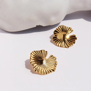 Artistic gold ginkgo leaf stud earrings with radial texture on minimalist stone