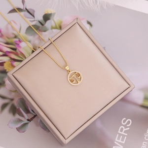 Macro detail of 18K gold Libra zodiac pendant featuring sparkling zircon micro-pave setting