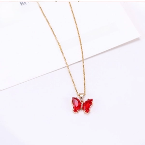 Detail of red crystal butterfly pendant with gold plating and white cubic zirconia