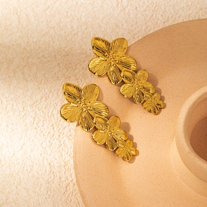Golden stainless steel triple flower dangle earrings with textured metallic petals