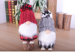 Close-up of red and grey Christmas gnomes with knitted hats and faux fur beards