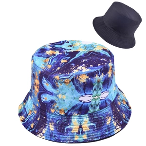Close-up of reversible bucket hat with blue marble pattern and gold ink details