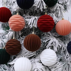 Set of 10cm flocked Christmas balls with stripe texture hanging on snowy pine branches
