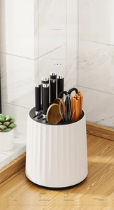 Close-up of rotating kitchen knife holder organizing knives and utensils on wooden countertop