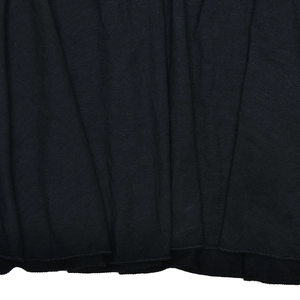 Detailed close-up of black knitted dress fabric texture and bottom hem stitching