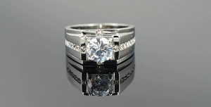 Macro shot of silver titanium wedding ring for men with brilliant round center stone