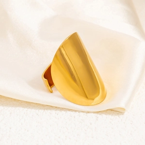 Detailed view of wide 18k gold-plated stainless steel ring on elegant beige silk fabric
