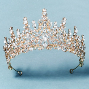 Macro detail of luxury gold bridal crown with purple crystals and sparkling rhinestones