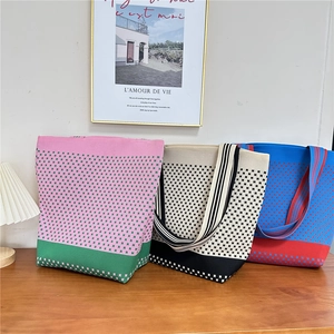 Detailed knit texture and geometric pattern of a large capacity shoulder tote bag
