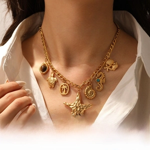 Detail of gold starfish and seahorse charms on a multi-pendant ocean theme necklace