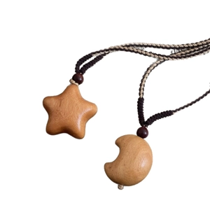 Handmade woven cord necklace featuring wooden star and moon pendants with natural wood grain