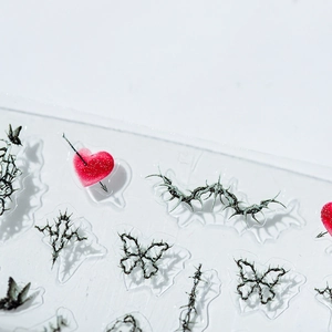 Dark aesthetic nail stickers featuring black thorn butterflies and glitter red heart patterns