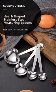 Detailed macro of heart-shaped stainless steel measuring spoons with engraved handle phrases