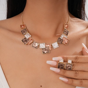 Detail of bohemian geometric square pendant necklace and matching studs with hammered texture