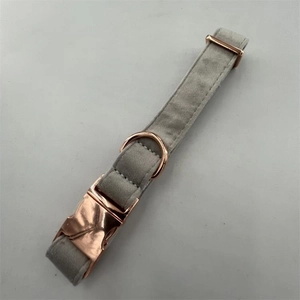 Detail view of gray velvet pet collar with polished rose gold metal buckle and D-ring