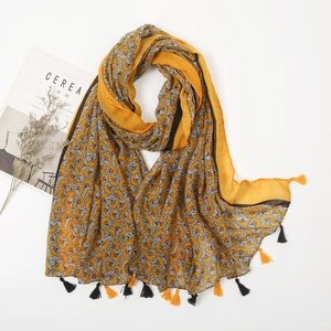 Detail of vintage floral cotton linen scarf with sunflower print and fringe tassels