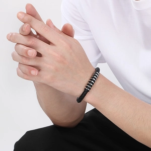 Men's punk black braided leather bracelet with silver stainless steel rings on wrist