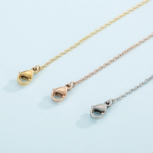 Close-up of lobster clasp and extension chain on flower bracelet in gold and silver