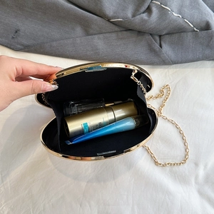 Elegant black oval acrylic evening clutch with gold metal frame and chain shoulder strap