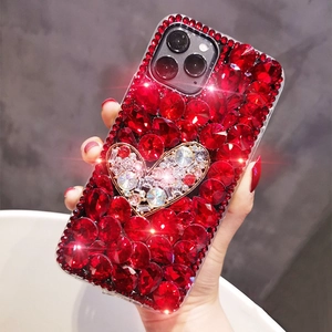 Close-up of luxury iPhone case with handcrafted deep red rhinestones and crystal heart detail