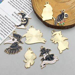 Detail of gothic enamel charms featuring plague doctor, crow, and moon with skull motifs