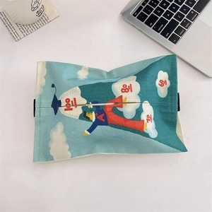 Top view of a blue linen car tissue box with cartoon student on a modern desk setup